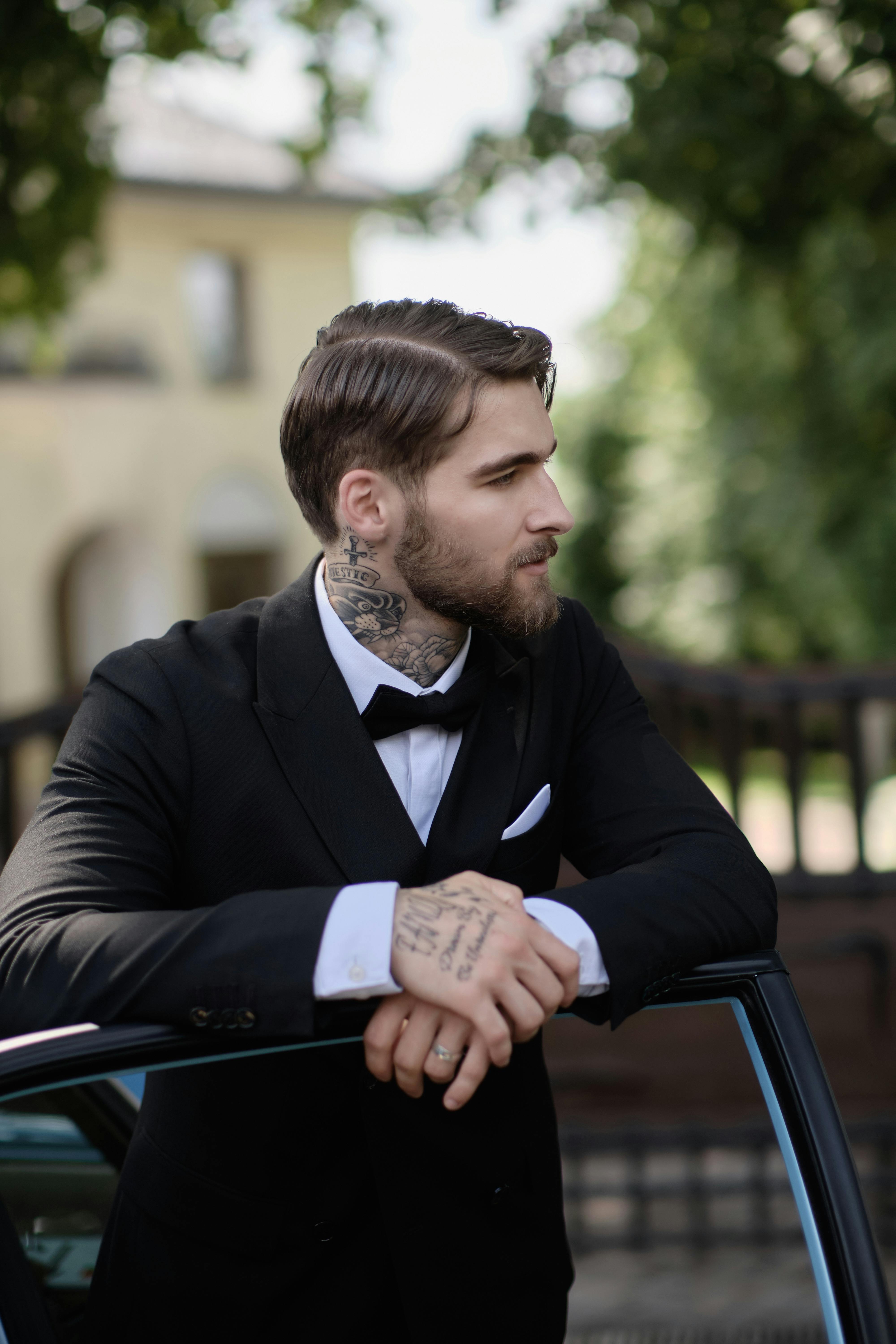Tattooed Man in a Suit · Free Stock Photo